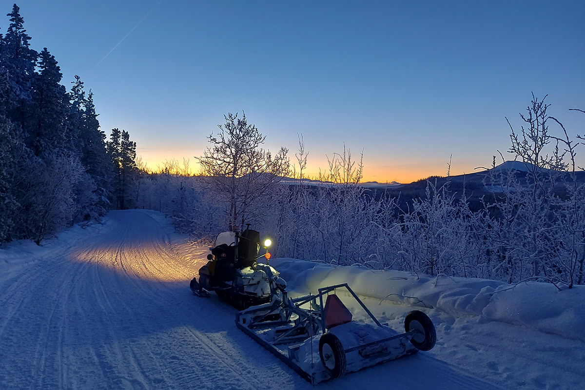 Klondike Snowmobile Association Volunteers grooming the McLean Lake trail at dawn - February 2023