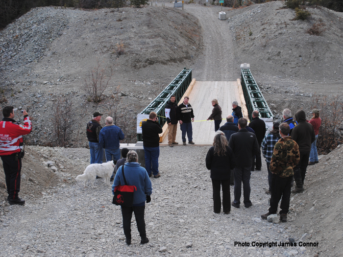 Deb Greenlaw cutting the ribbon at the Grand Opening of the Peter Greenlaw Memorial Bridge over Wolf Creek on the Copper Haul Trail  -  October 2011