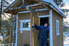 K.S.A. volunteer Harris Cox taking a break at the half-way warm up cabin on the Dawson Overland Trail - February 2025