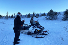 Taking a coffee break with the moose on Mt. McIntyre on the Klondike Snowmobile Association's annual Take A Friend Snowmobiling ride - February 2025